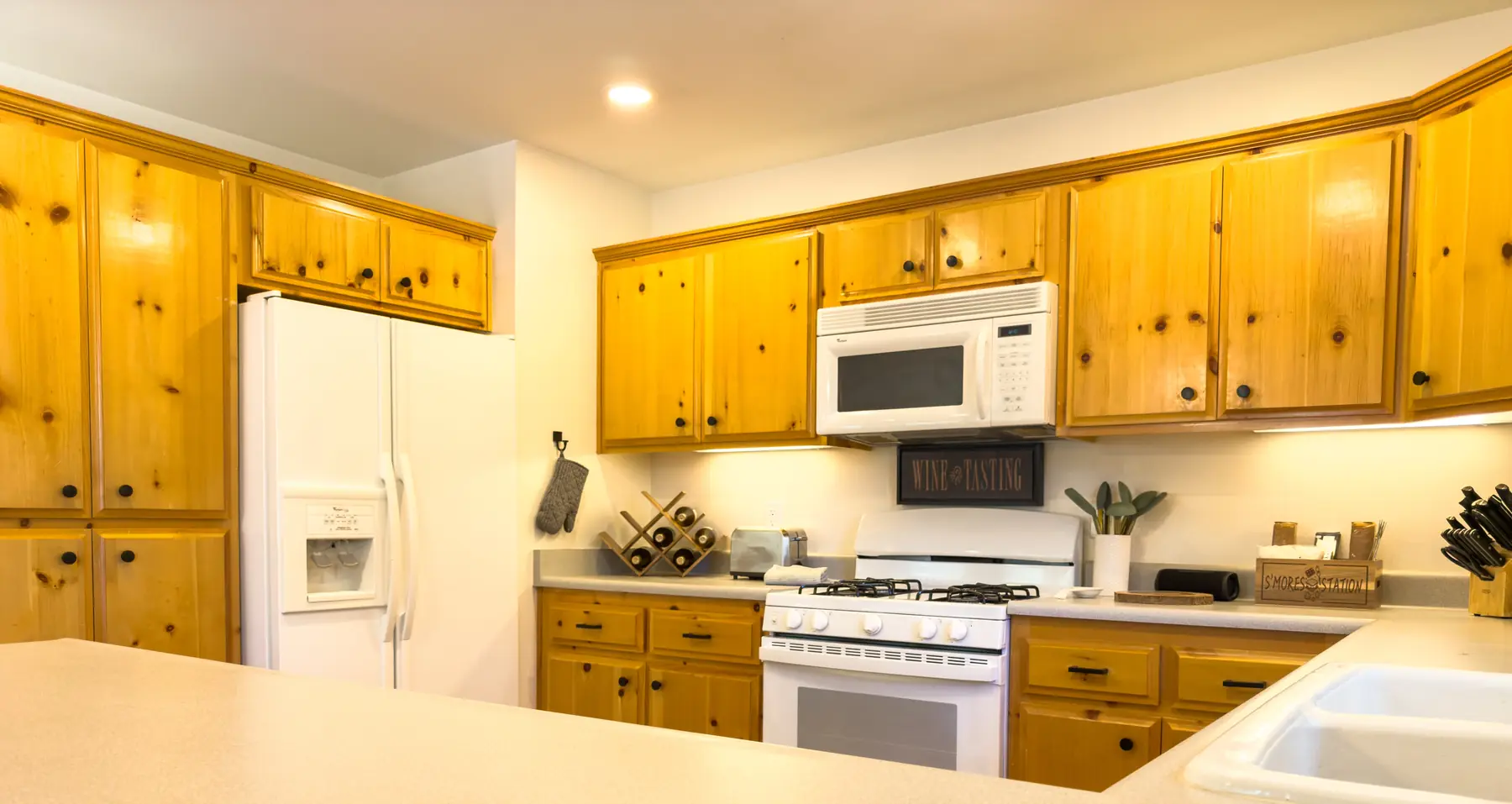 Wide view of the kitchen at Pine Grove Cabin with breakfast bar seating
