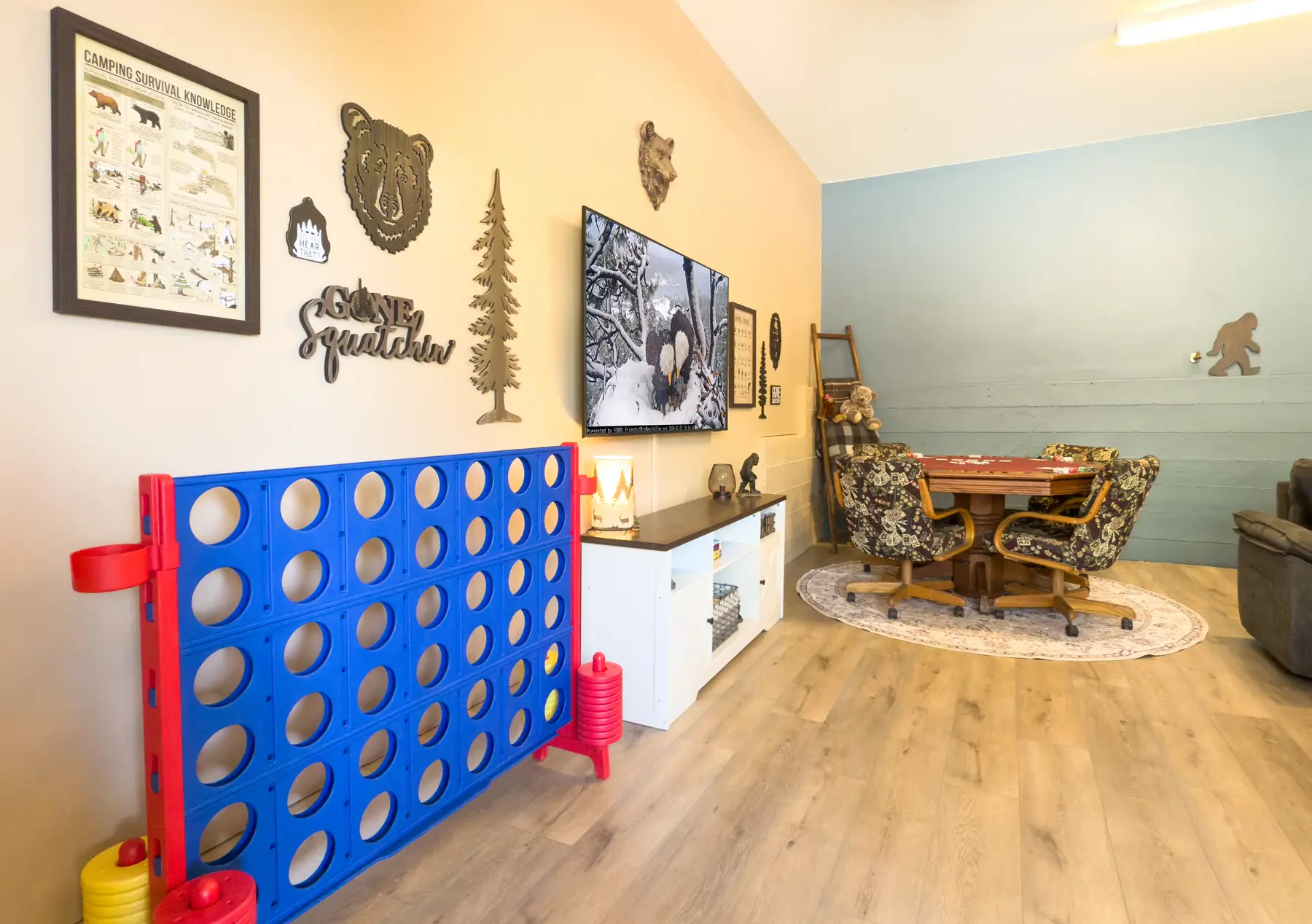 The Sasquatch Den poker table and Bigfoot-themed wall decor at Pine Grove Cabin